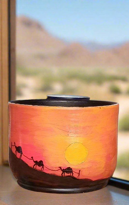 Hand-painted pot ___ sunset in a desert